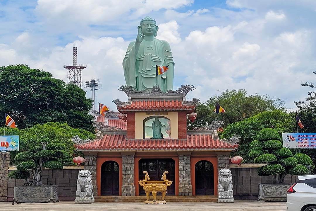 Admire the statue of Amitabha Buddha