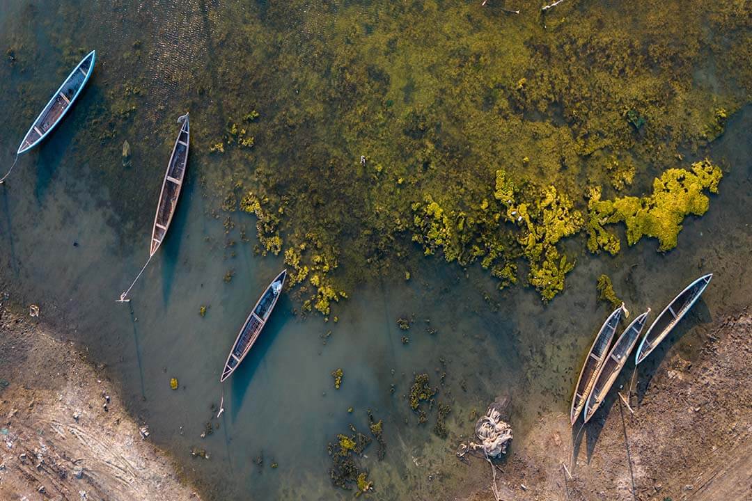 Aerial view of traditional boats at O Loan Estuary in sunset