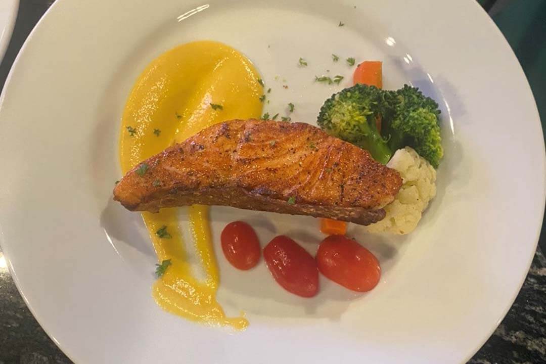 Salmon with lemon sauce at Victor Rooftop Bar Restaurant