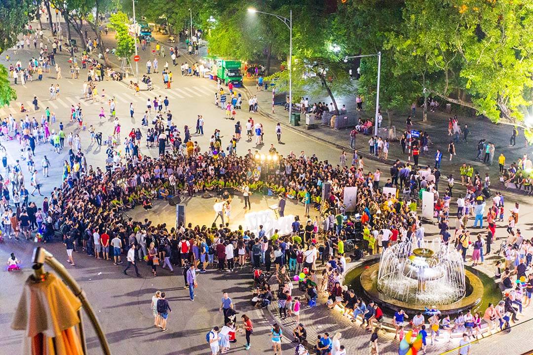 There are so many people watch outdoor show at Hanoi Old Quarter Night Market in weekend