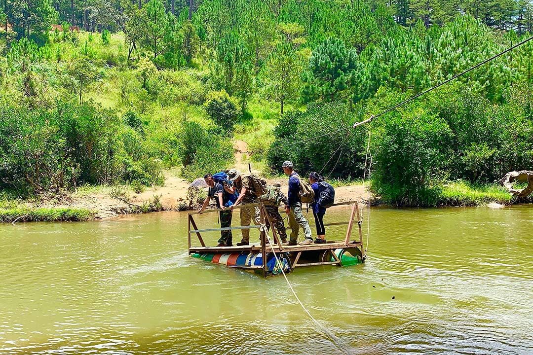 Crossing the river to continue hiking at Bidoup Nui Ba National Park